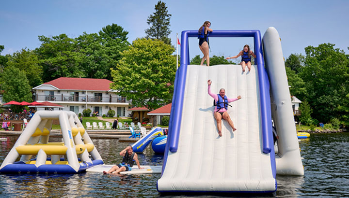 Families enjoying beach and water sports at Severn Lodge Muskoka
