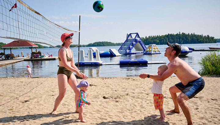 Families enjoying beach and water sports at Severn Lodge Muskoka
